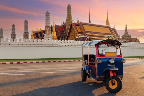 Tuk Tuk Taxi or Three-Wheel Vehicle with Wat Phra Kaeo background