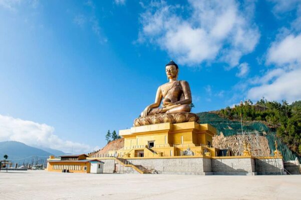 A giant Buddha statue under blue sky in Thimphu, Bhutan