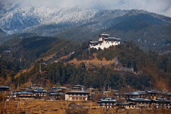 Morning snowfall on the forest covered mountains behind Jakhar Dzong above Jakar, Bhutan