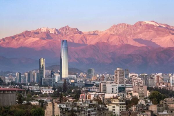 Aaerial view of Santiago skyline at sunset with Costanera skyscraper and Andes Mountains, Santiago