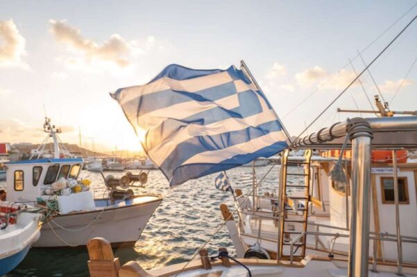 Greek flag on boat, Naoussa harbour, Paros, Greece