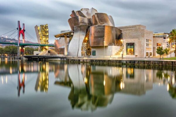Reflection of the Guggenheim Bilbao museum and La Salve bridge on the Nervion river in Bilbao, Spain