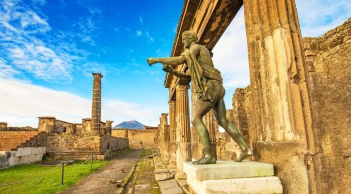 Ancient Pompeii city skyline and bronze Apollo statue, Italy