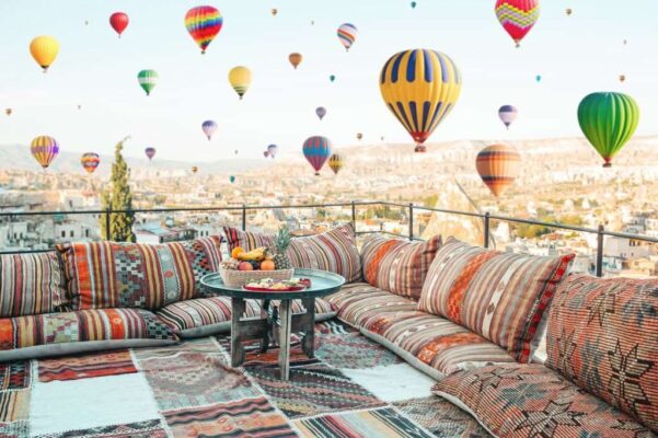 View of the city of Goreme with caves and air baloons in Cappadocia, Turkey