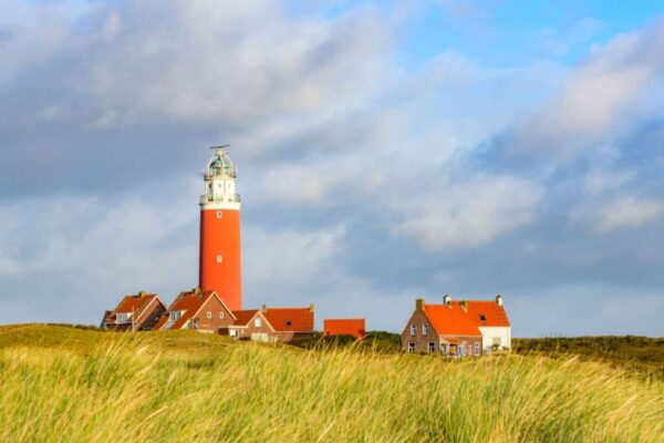Texel lighthouse in the dunes during a stormy autumn night