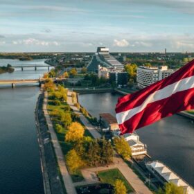 Aerial panorama of Riga city with a big Latvian flag