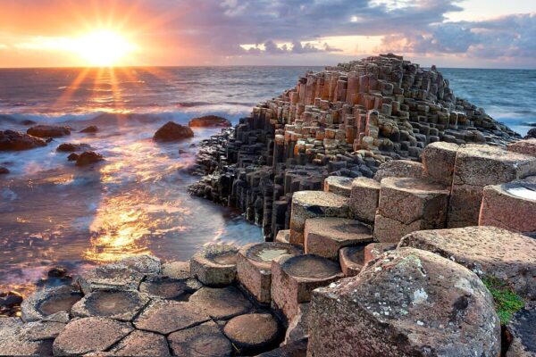 People visiting Giant s Causeway at the sunset in North Antrim