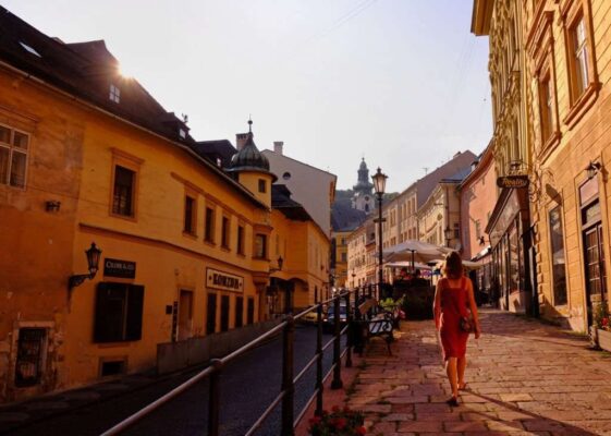 Woman walking thru historical mining town of Banska Stiavnica